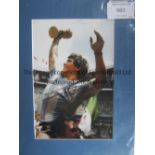 MARADONA Mounted signed photo of Diego Maradona with the 1986 World Cup. Generally good