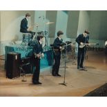 THE BEATLES A 10" x 8" reprinted colour press photo with a stamp on the reverse showing the band