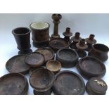 A box of turned wood items including candlestick holders