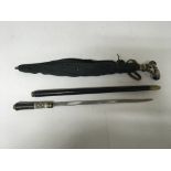 A short sword stick and umbrella with intricate handle design.