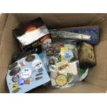 A large box containing oddments to include Southend Airshow badges, tins and other items. Some