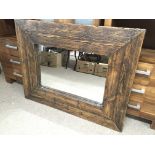 A modern design rustic stained pine wall mirror with metal corner brackets 95x121cm