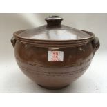 A large earthen ware cooking pot and lid with lustre glaze