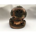 A large brass scuba divers helmet.