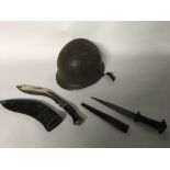 A small group of items to include a US WW2 military helmet a hunting knife with a leather scabbard
