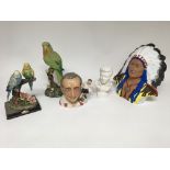 A group lot of ceramics and resin figures to include two parrot figures, a Sir Stanley Matthews