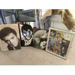 An Elvis Presley mirror and three Elvis pictures.