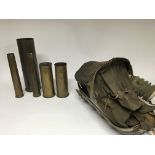 A group of military items to include trench art esque shell cases and a gas mask carrier for a