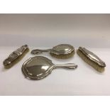 A silver brush set and mirror, Chester hallmarks.