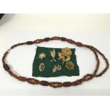 A carved amber necklace plus silver and gilt filig