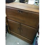 A Ercol cabinet fitted with a fall front cupboards