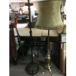 A brass standard lamp plus a wrought iron example