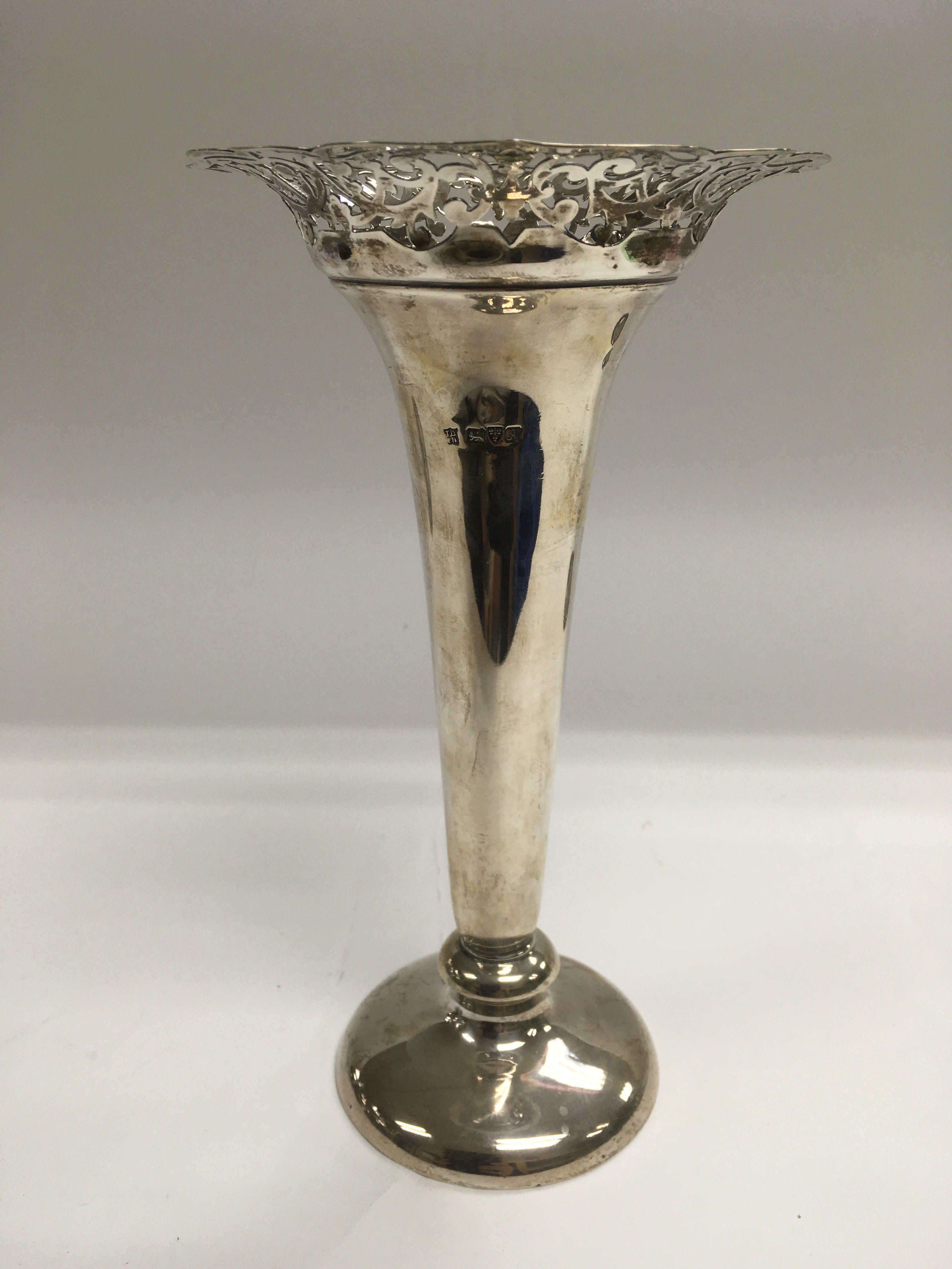 A silver vase of tapering form with a piercework r