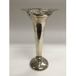 A silver vase of tapering form with a piercework r