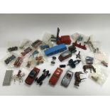 A box of die cast vehicles and lead farm figures.