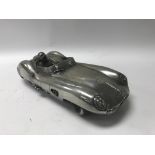 A chromed model of an Aston Martin DBR1/2 with dri