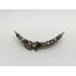 A 14ct gold multi stone crescent shaped brooch, ap