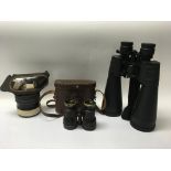 Two pairs of binoculars and a gas mask, one binocu