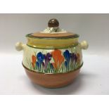 A Clarice cliff biscuit barrel decorated in the cr