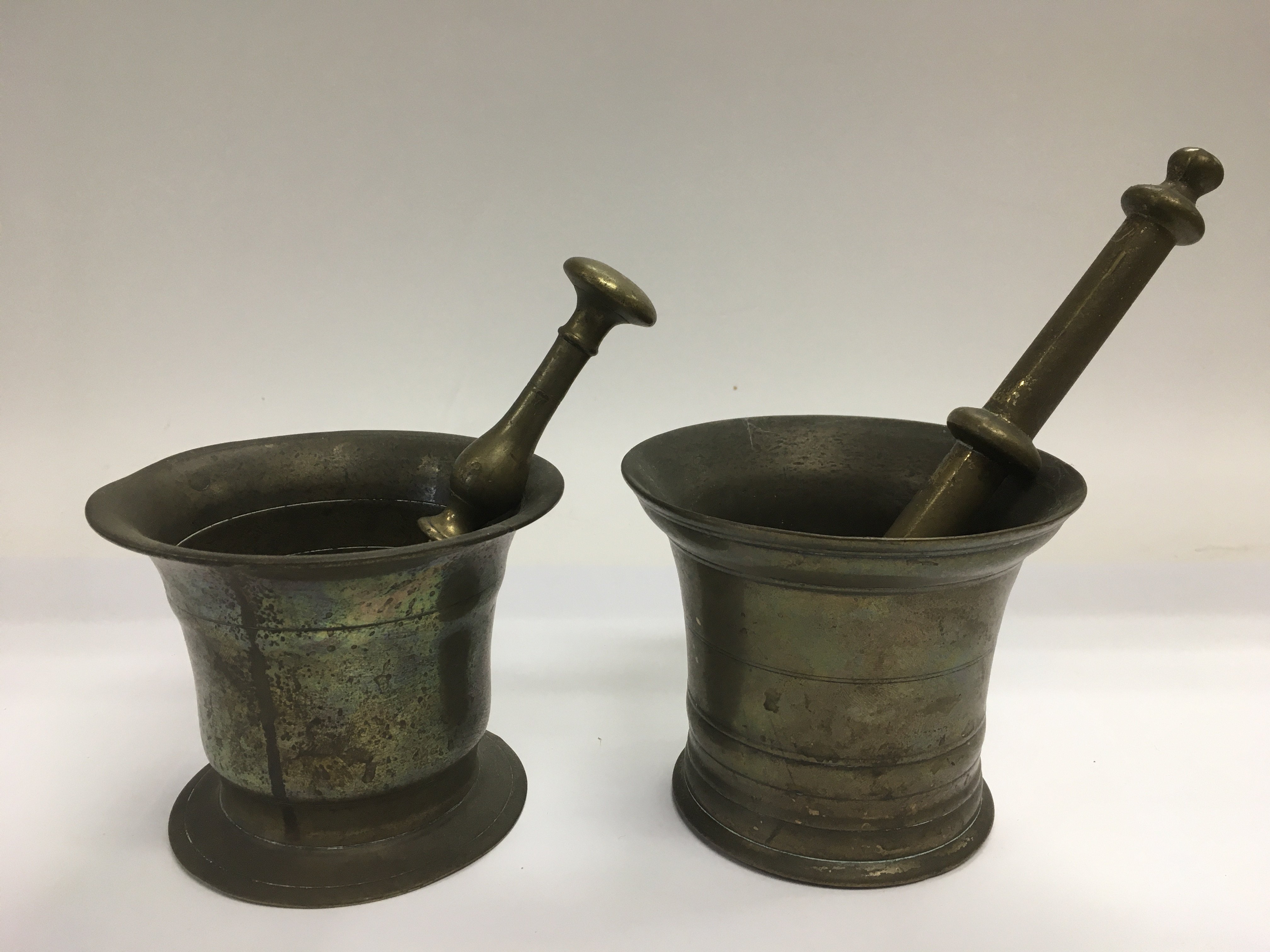 Two similar bronzed pestle and mortars.