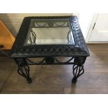 A cast iron occasional with glass top .