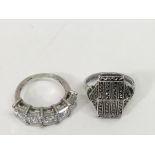 Two silver rings, one set with CZ, the other of ma