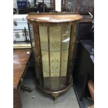 A small walnut display cabinet of semi-circular sh