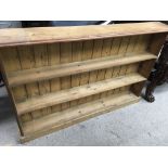 A pine book case fitted with two selfs