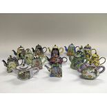 A collection of miniature enamel teapots.