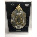 A limited edition silver plaque depicting the insi