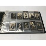 An album containing Ogden's cigarette cards, large