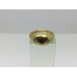 An 18ct gold ring set with a central sapphire with