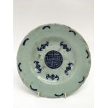 A Chinese celadon shallow dish painted with 'five