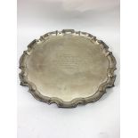 A large silver tray with pie crust edge having engraved presentation and signatures relating to
