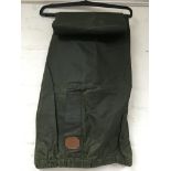 A pair of green Burberry waxed fishing trousers