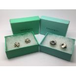 Two pairs of boxed Tiffany & Co ear clips.