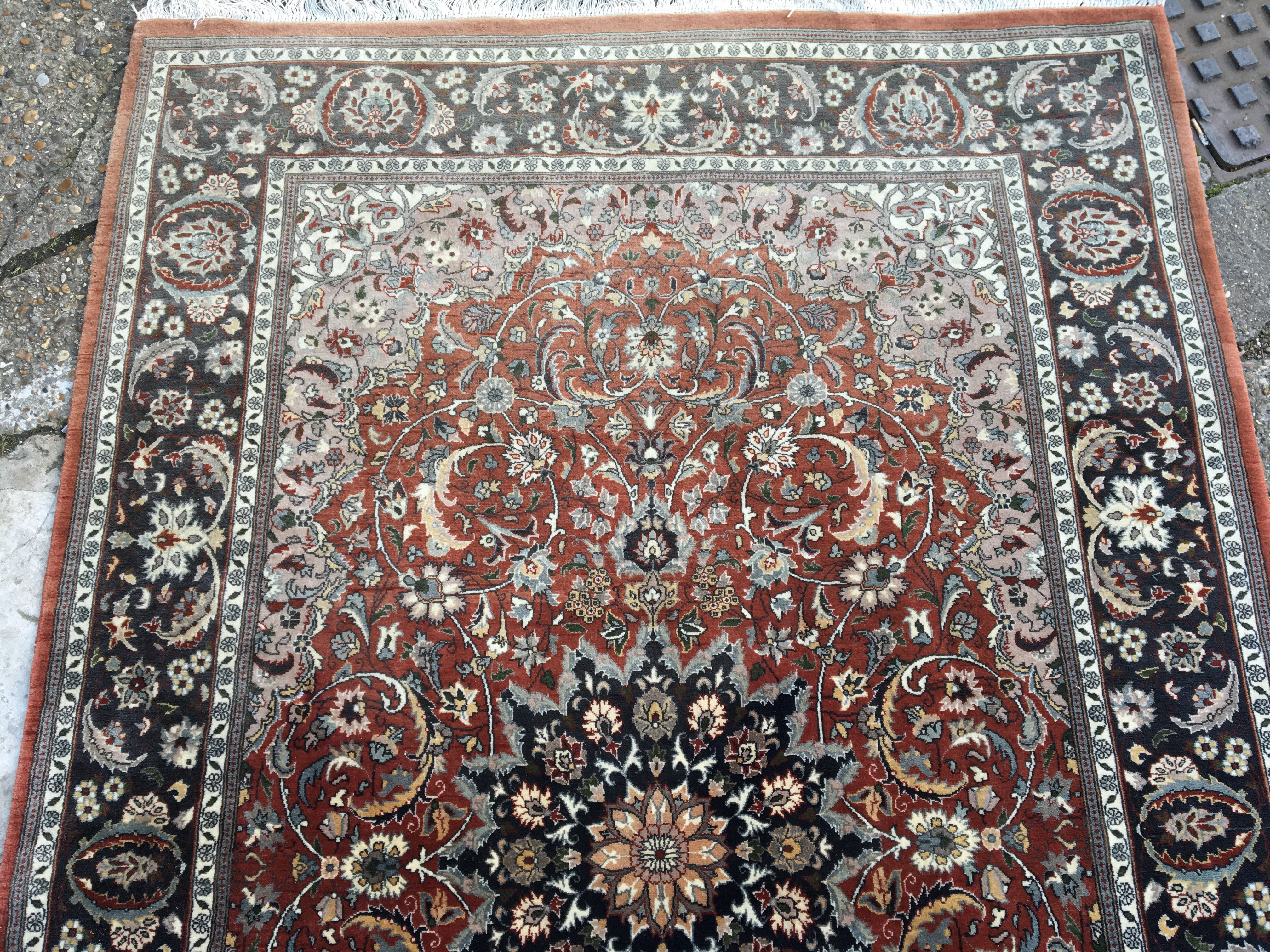 A hand knotted Persian rug with a large red centra - Image 2 of 3