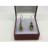 A pair of 9ct white gold and citrine earrings, app