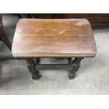 A oak joint stool.with carved rails and bob in leg