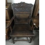 An 18th century provincial oak chair with carved b
