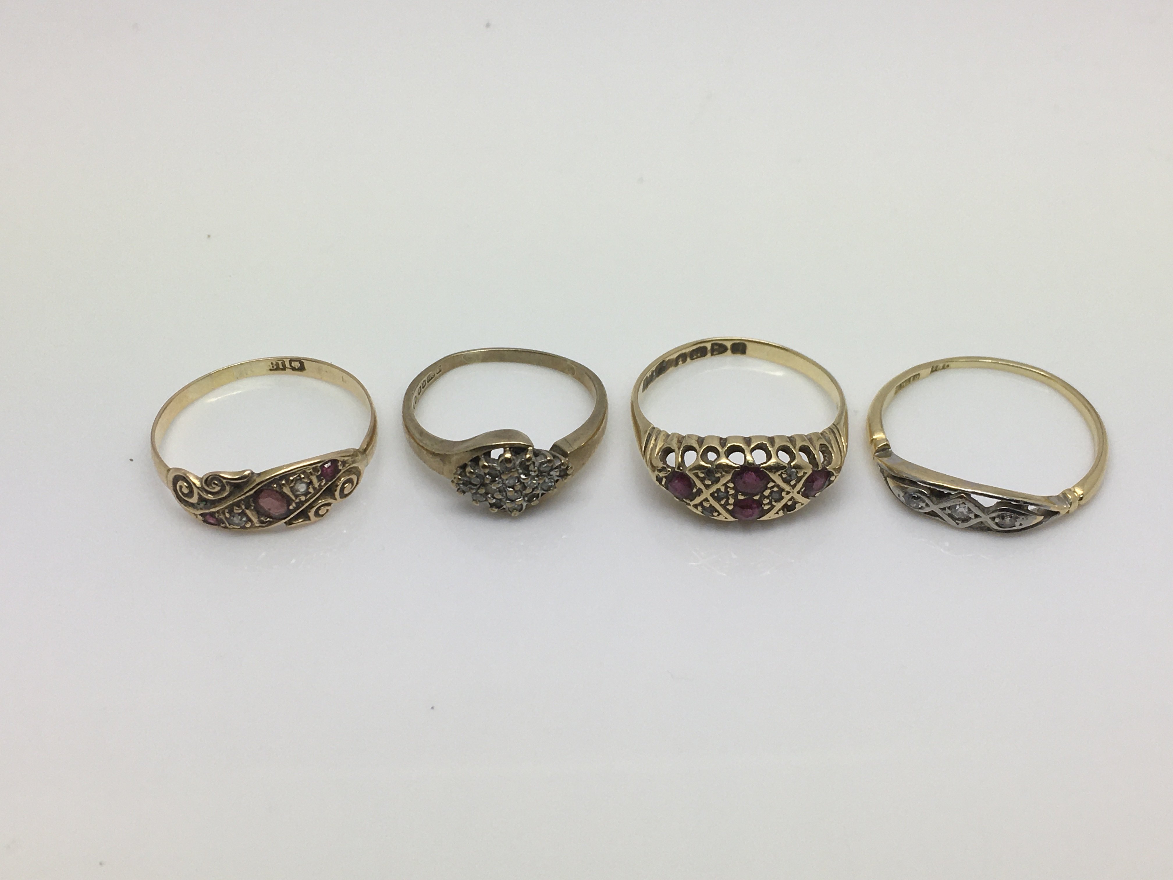 Four gold rings set with diamonds and other stones