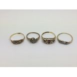 Four gold rings set with diamonds and other stones