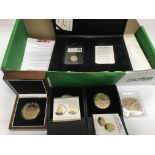 A collection of boxed commemorative coins, some pr