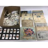 A collection of cigarette cards, loose and in albu