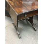 A William IV small size sofa table the twin flap top above a drawer with splayed legs