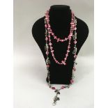 A similar lot of two, long pink cultured pearl nec