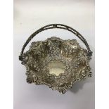 An unmarked silver, swing handle basket of folate design with repousse decoration.Approx 155g