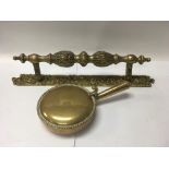 An old brass door handle and brass lidded dish.