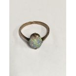 A 9 ct gold ring inset with a single opal