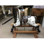 A modern, painted wooden 'Horseplay' rocking horse